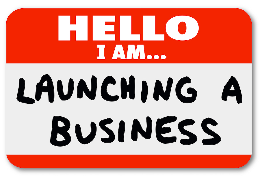 Hello I Am Launching a Business words on a nametag sticker to introduce yourself as an entrepreneur or company owner starting or beginning a new venture