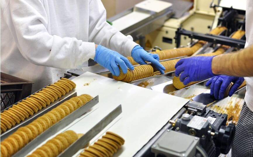 workers packing biscuits in factory